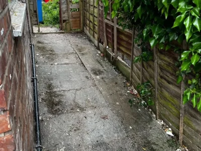 Mini digger breaking driveway concrete