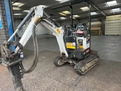 Mini excavator loading broken concrete