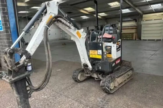 Mini excavator loading broken concrete