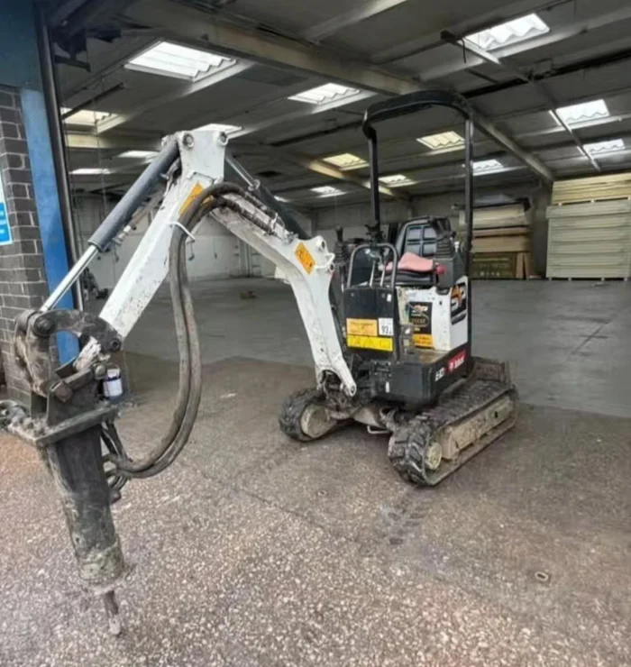 Mini excavator loading broken concrete